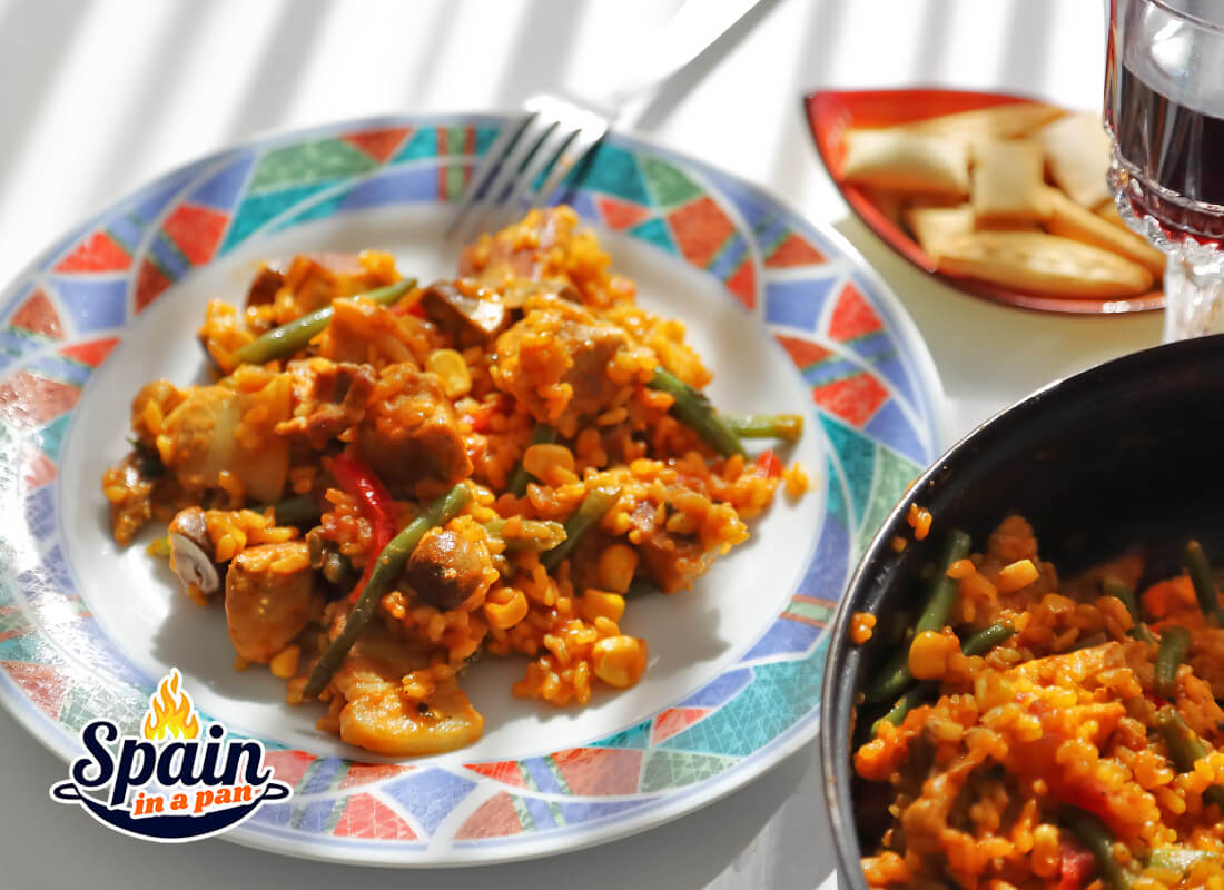 Spanish pork belly rice on a decorative plate. Spanish pork belly rice on a decorative plate.