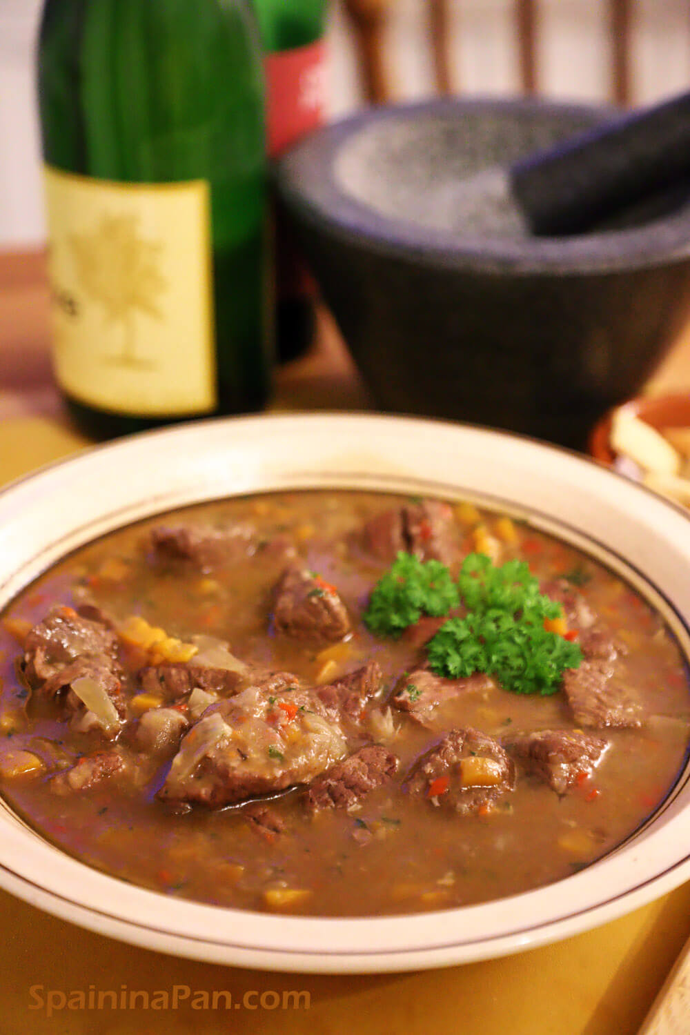 Spanish spicy beef stew on a rustic plate.