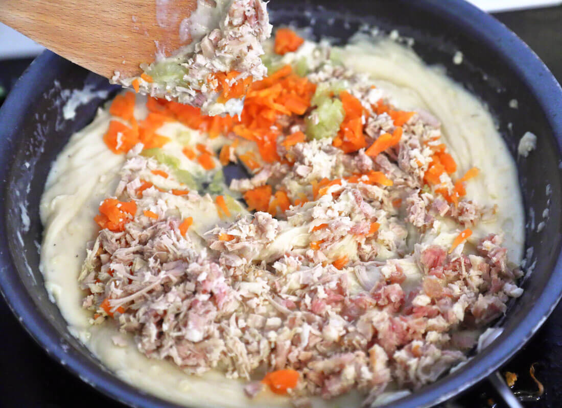 Spanish stew croquettes mix with bechamel sauce in a pan.