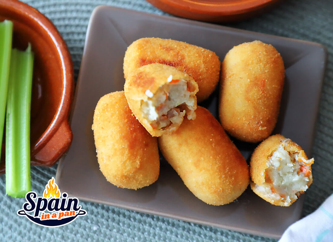 Spanish cocido stew croquettes on a saucer.