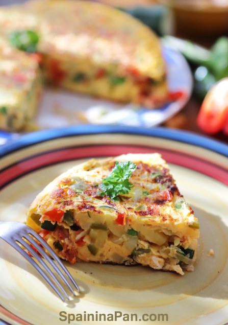 Spanish tortilla paisana slice on a decorative plate.