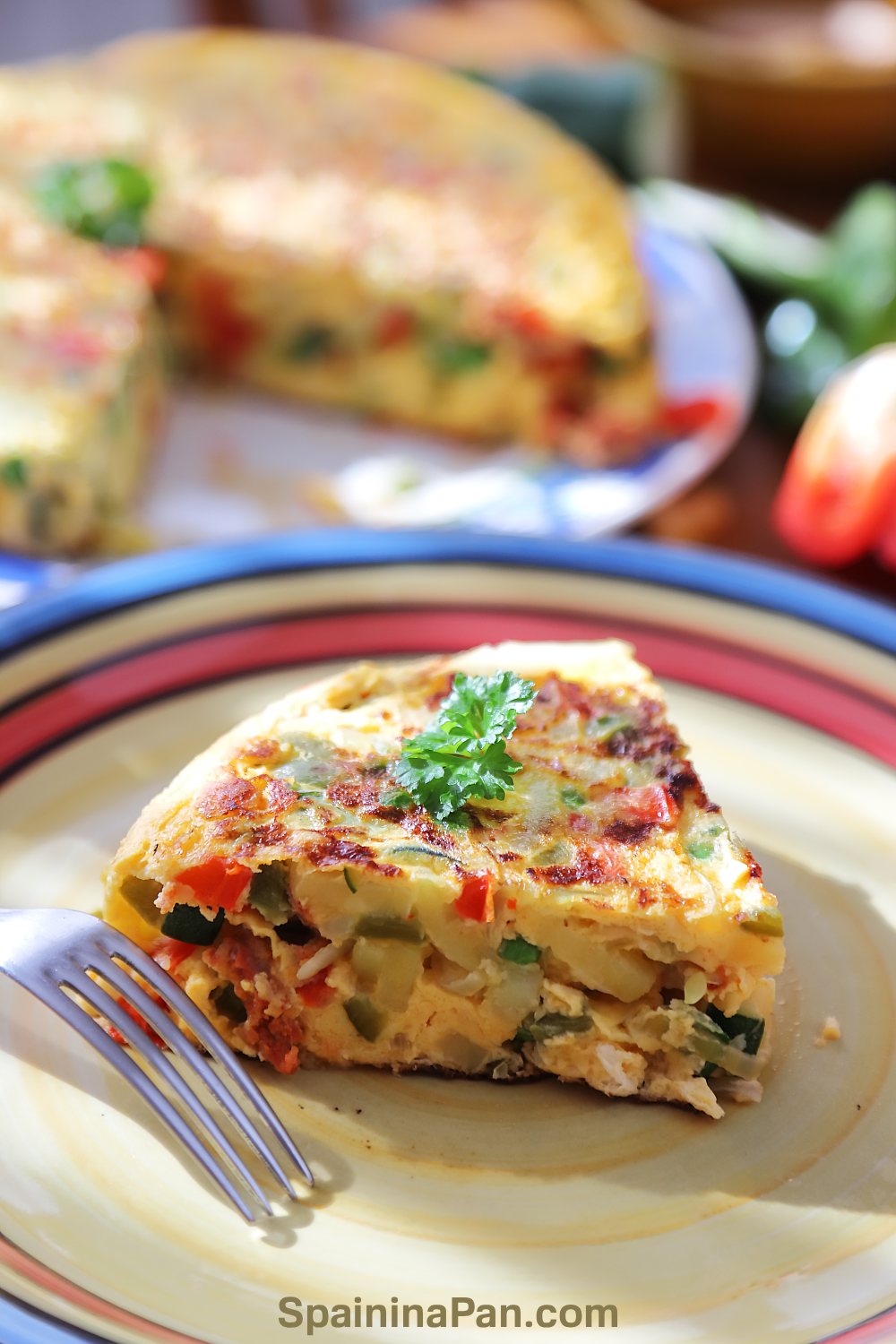 Spanish tortilla paisana slice on a decorative plate.