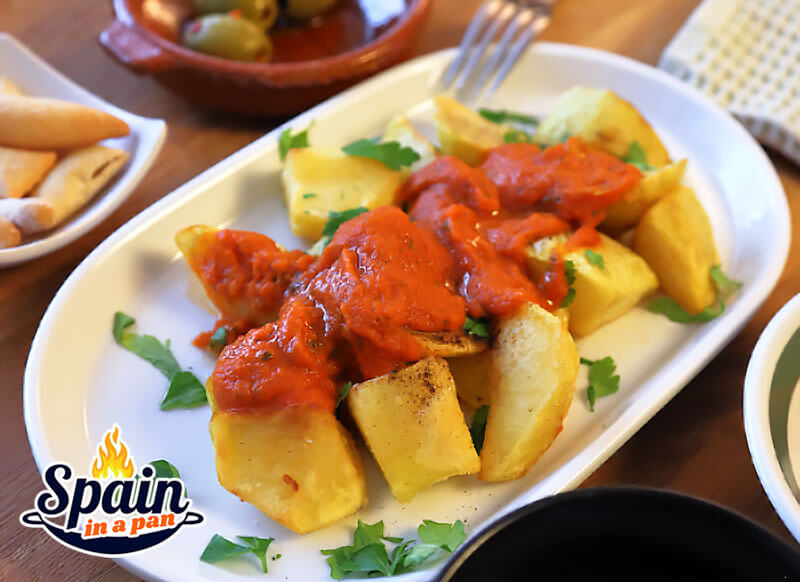 Patatas bravas with tomato-based salsa brava.