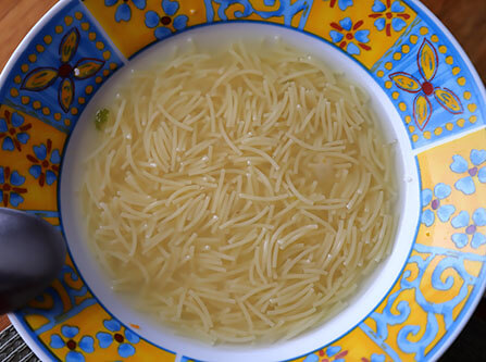 Vermicelli soup in a bowl from a Madrilenian cocido stew.